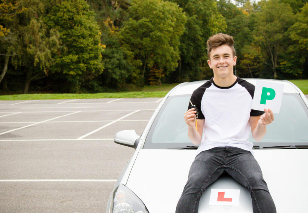 Learner driver sitting on a car