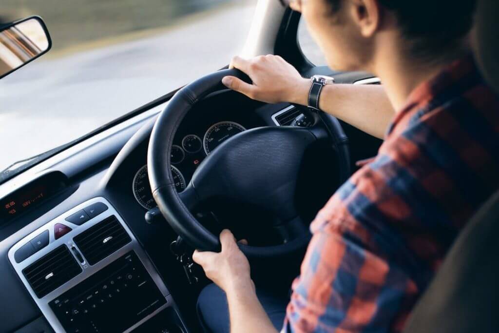 Over the shoulder photo of man driving