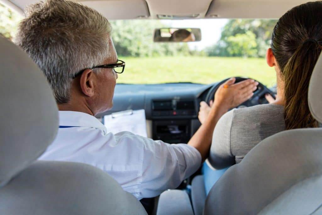 Man teaching woman how to drive