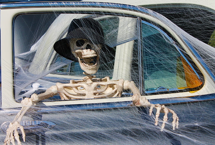 skeleton driving a car