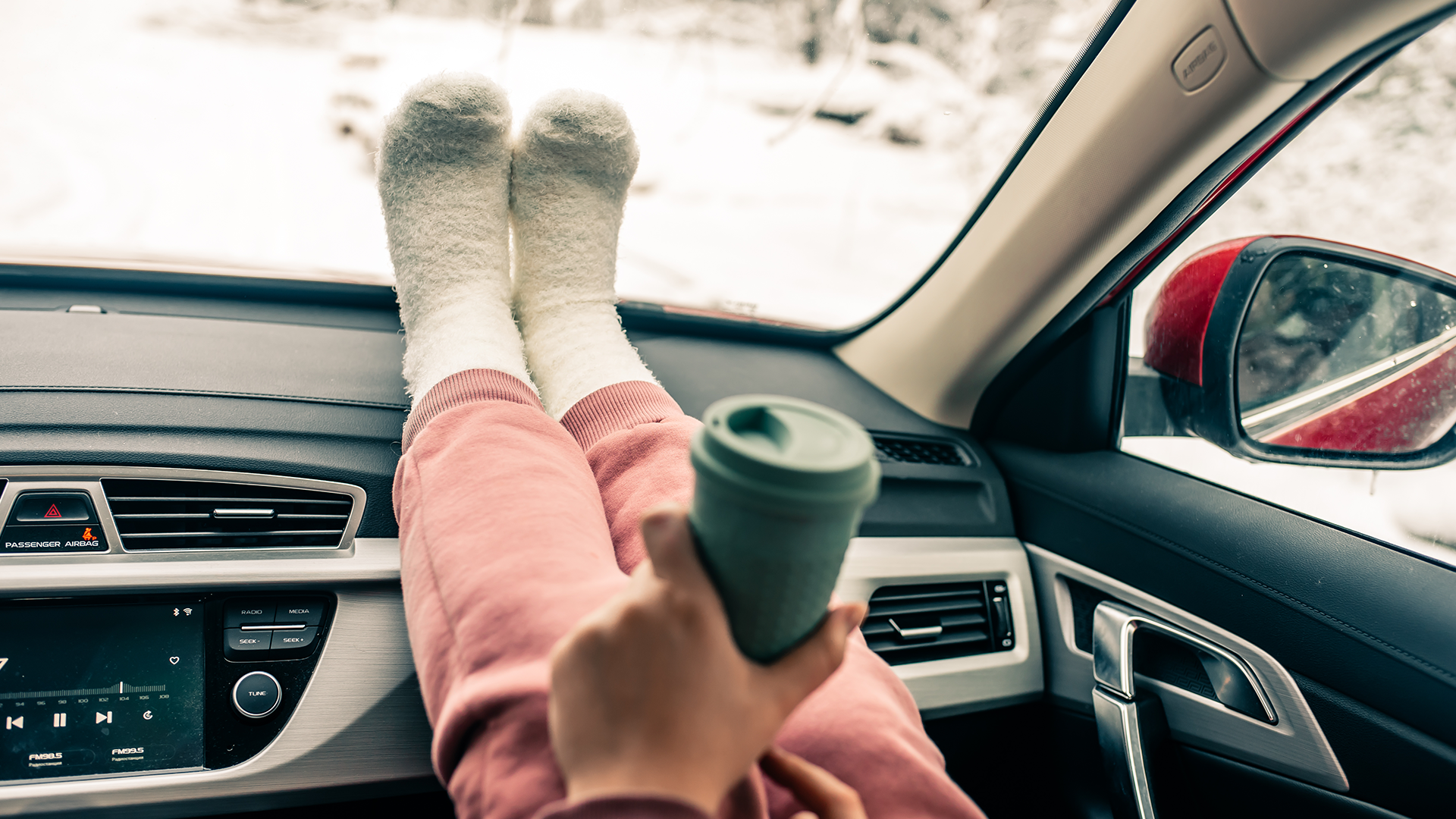 Cosy socks resting on car dashboard