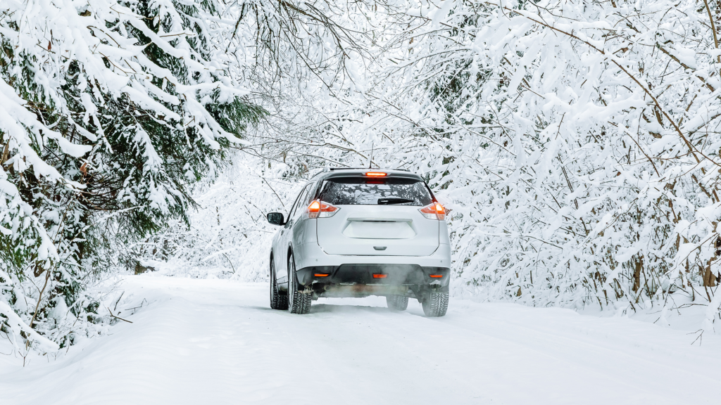 Car driving through a wintry scene