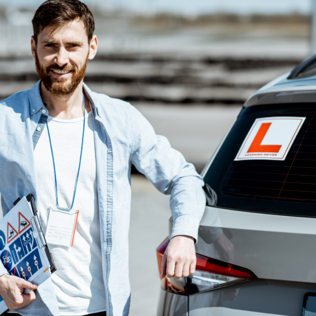 Learner driver smiling and standing in front of a car